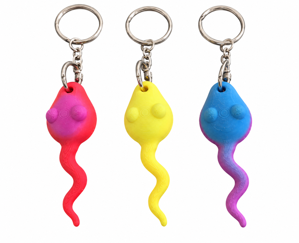 Three 3D Printed novelty keychains shaped like sperm in pink, yellow, and blue, shown on a plain white background.