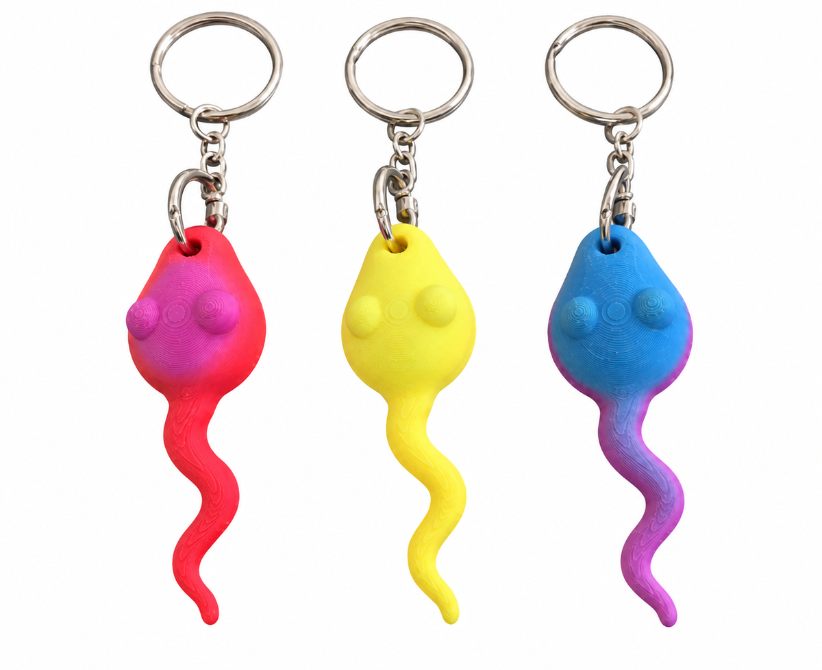 Three 3D Printed novelty keychains shaped like sperm in pink, yellow, and blue, shown on a plain white background.