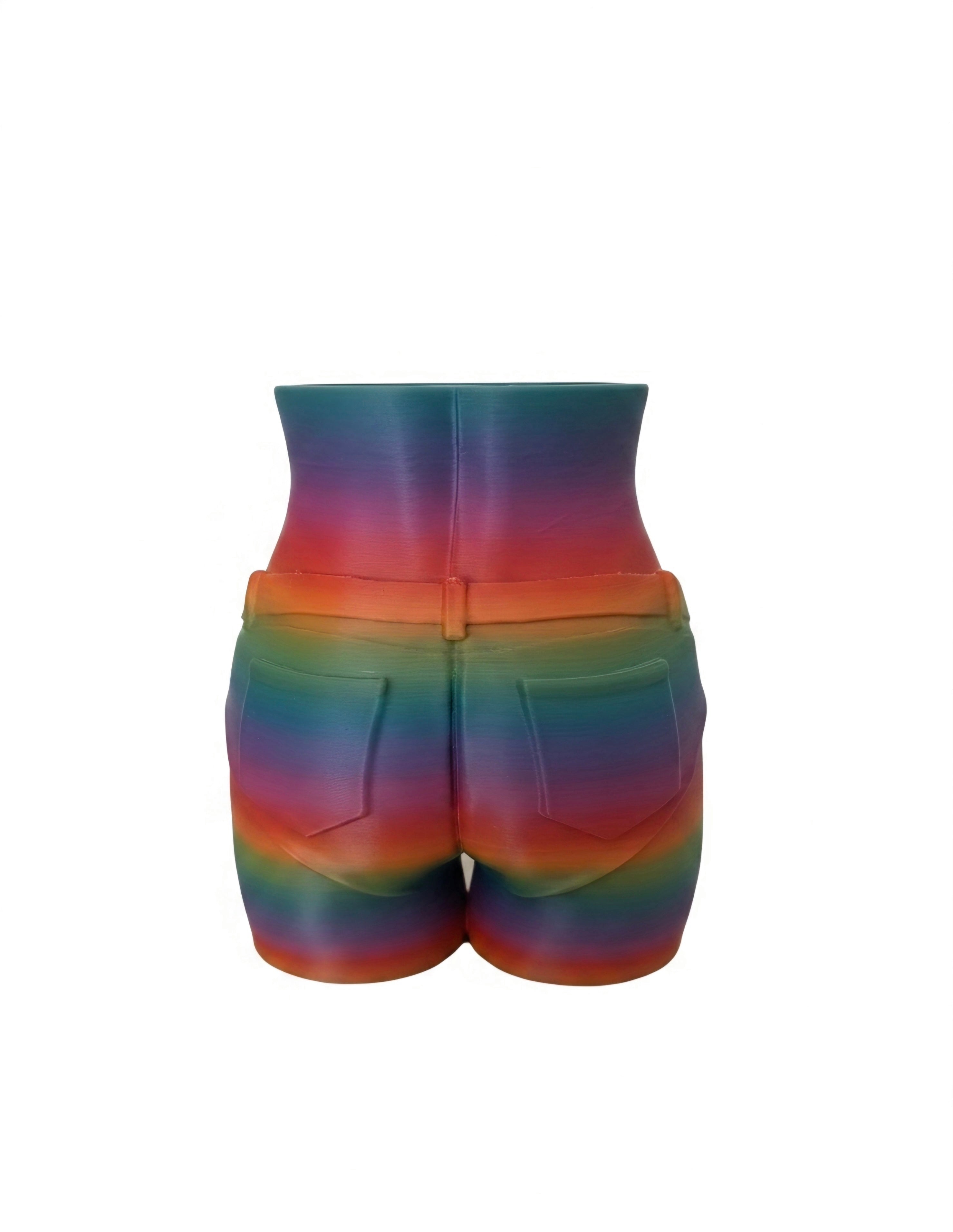 A pair of high-waisted shorts with a vibrant rainbow gradient pattern, featuring a waistband with a central seam and faux pocket details on the back, shown against a plain white background.