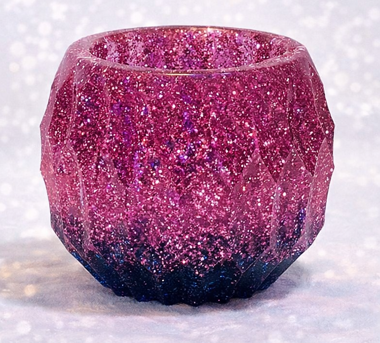 Pink glittery candle holder on a white background