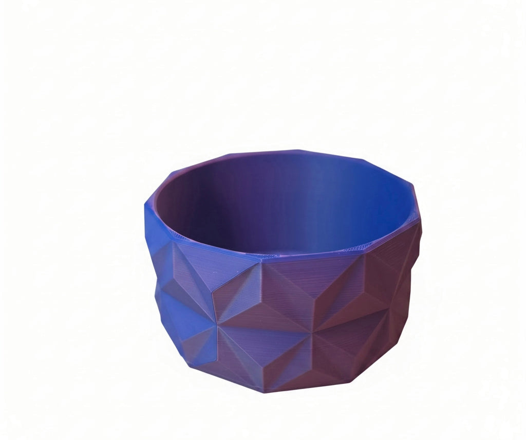 A faceted geometric bowl with a faceted, low-poly design, shown on a plain white background.