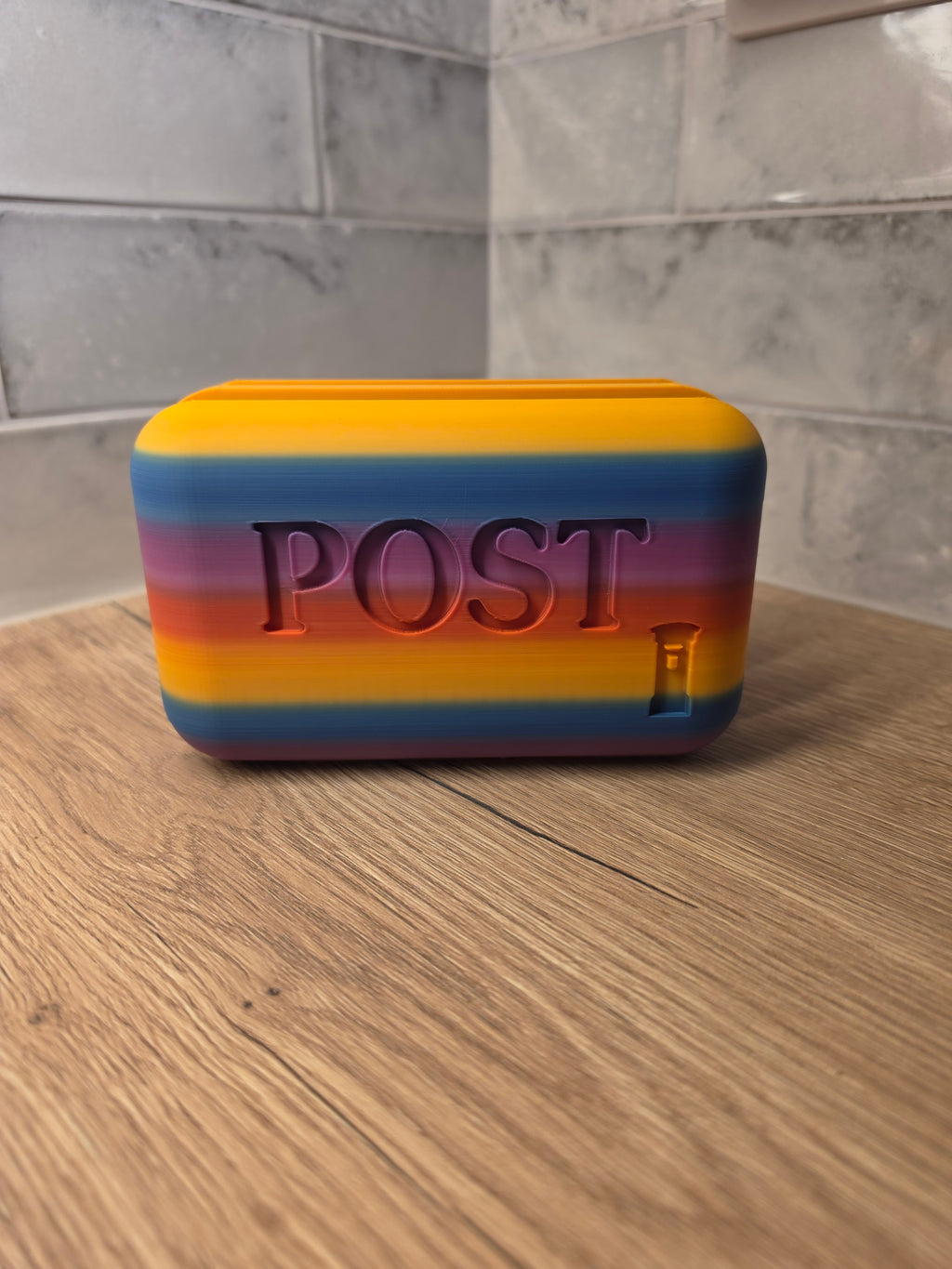 Colourful letter rack with 'POST' branding on the surface.