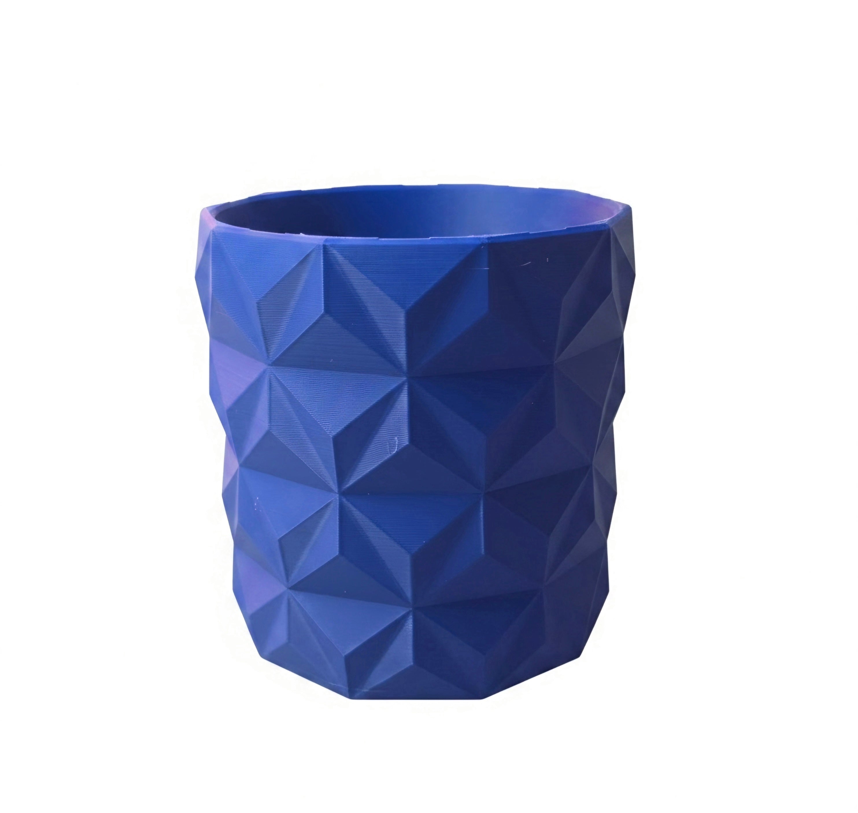 A blue and red planter pot with a geometric, faceted triangular pattern, shown against a plain white background.