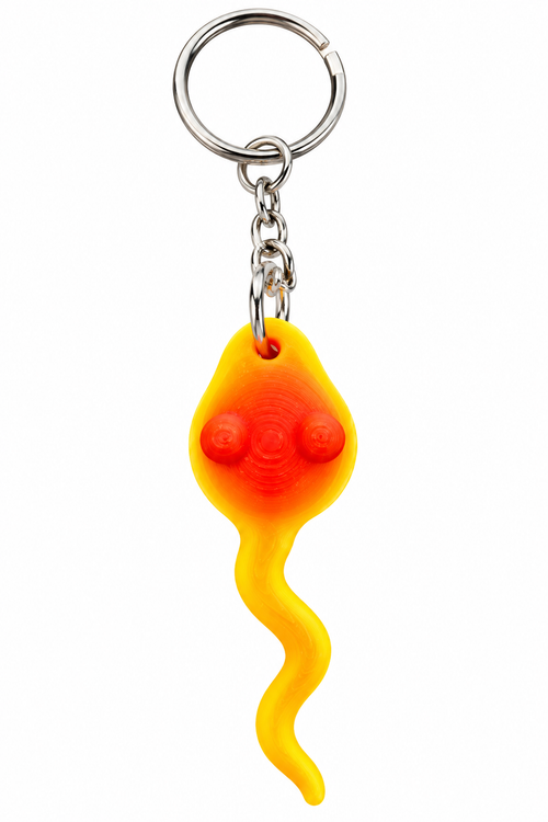 A novelty keychain shaped like a sperm, featuring a translucent yellow and orange body with red details, attached to a silver metal split ring and chain, shown on a plain white background.